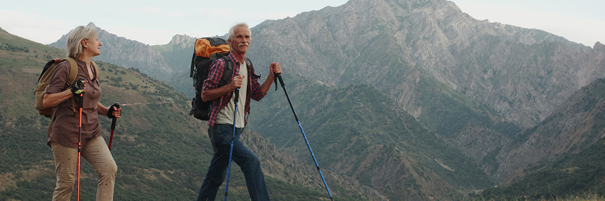 older man and woman hiking through utah mountains