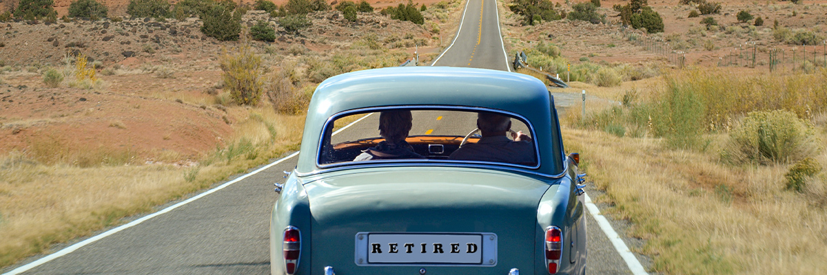 Classic car driving down a country road