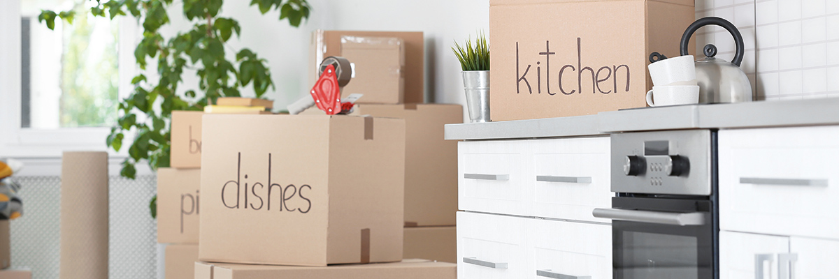 Moving boxes labeled in a kitchen