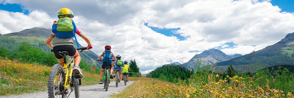 Kids on mountain bikes on mountain trail