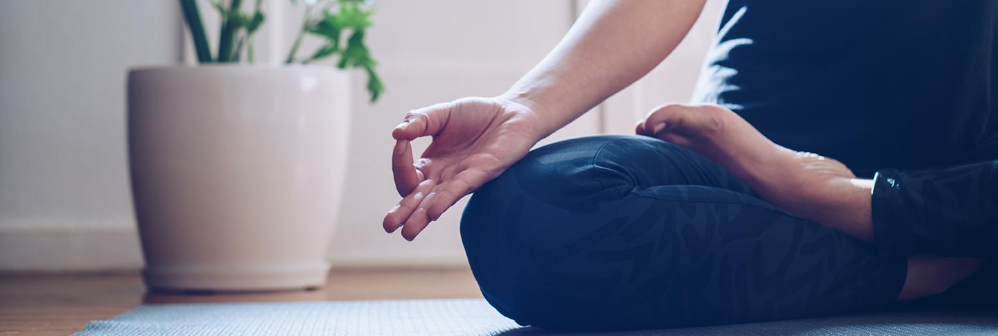 Person in yoga pose on floor